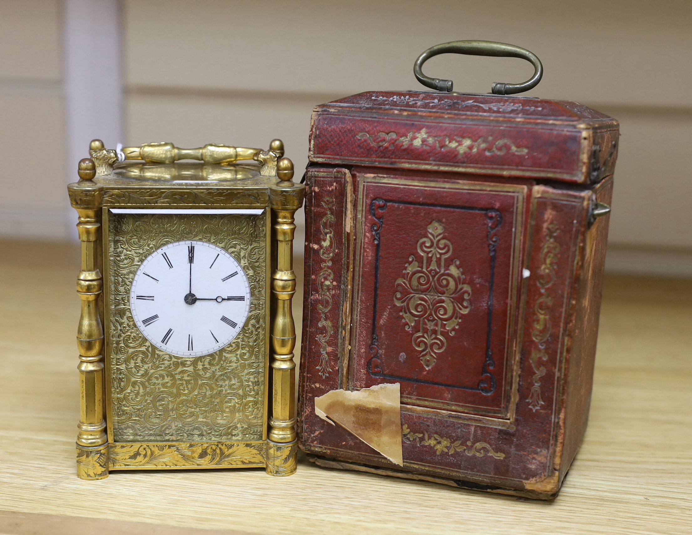 A mid 19th century French engraved gilt brass carriage clock, with tooled leather case, 16cm high